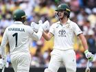 Sam Konstas of Australia (right) celebrates his half century with fellow opener Usman Khawaja.