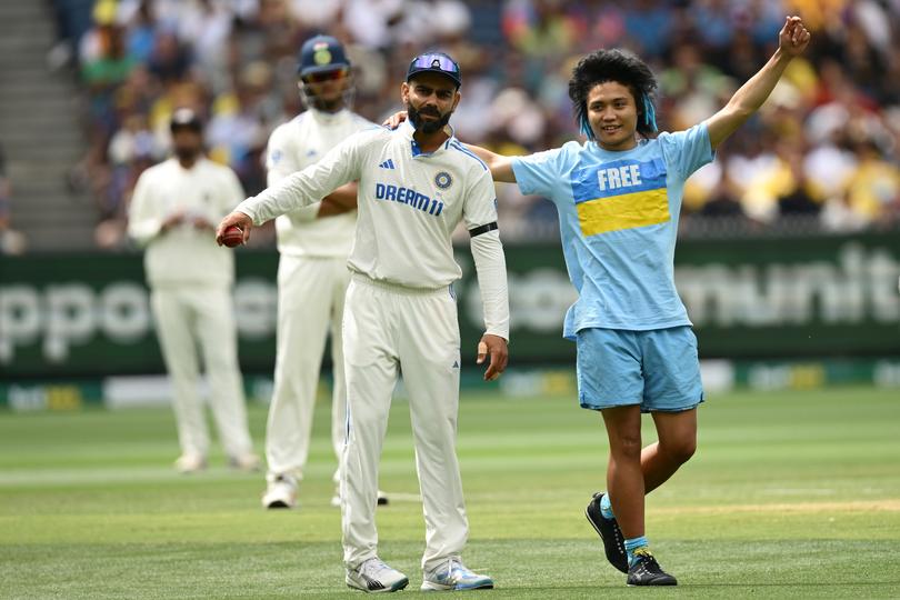 The pitch invader with Virat Kohli.