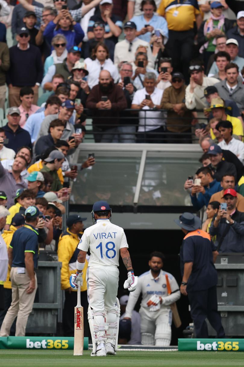 Virat Kohli of India leaves the field after being dismissed by Scott Boland.