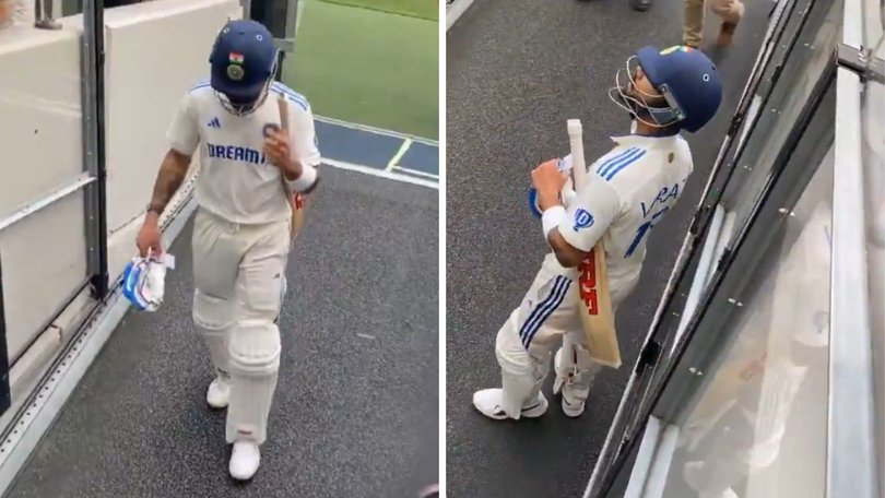 Virat Kohli reacts to fans after being booed off.