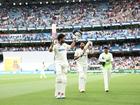 Nitish Kumar Reddy of India lifts his bat as he leaves the field.