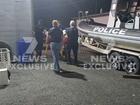 A man is taken away by paramedics after the shark attack on Humpy Island, off the central Queensland coast.