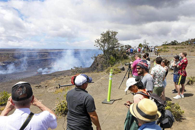 Visitors line the side of an overlook to view the Kilauea eruption in Hawaii.