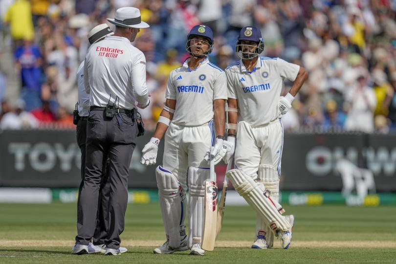 India's Yashasvi Jaiswal, center, speaks to umpires after being dismissed during play on the last day of the fourth cricket test between Australia and India at the Melbourne Cricket Ground, Melbourne, Australia, Monday, Dec. 30, 2024. (AP Photo/Asanka Brendon Ratnayake)