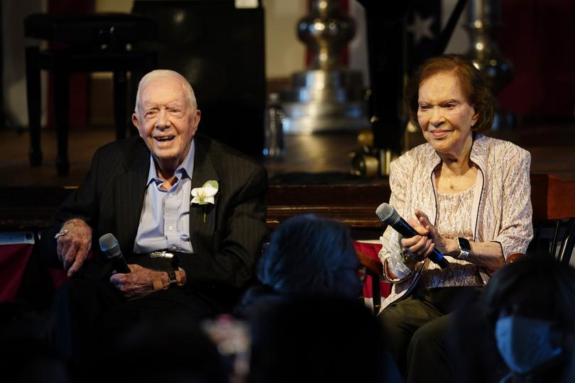 Former President Jimmy Carter, left, and his wife, former first lady Rosalynn Carter, sit together during a reception to celebrate their 75th anniversary, July 10, 2021.