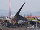 Rescue team members work at the site of a plane fire at Muan International Airport in Muan, South Korea, Monday, Dec. 30, 2024. 