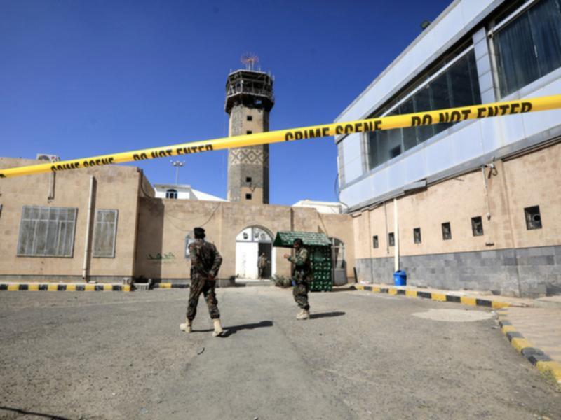 Houthi soldiers stand guard at Sana'a airport after Israeli air strikes hit the facility. 