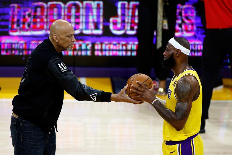 LOS ANGELES, CALIFORNIA - FEBRUARY 07: Kareem Abdul-Jabbar ceremoniously hands LeBron James #6 of the Los Angeles Lakers the ball after James passed Abdul-Jabbar to become the NBA's all-time leading scorer, surpassing Abdul-Jabbar's career total of 38,387 points against the Oklahoma City Thunder at Crypto.com Arena on February 07, 2023 in Los Angeles, California. NOTE TO USER: User expressly acknowledges and agrees that, by downloading and or using this photograph, User is consenting to the terms and conditions of the Getty Images License Agreement. (Photo by Ronald Martinez/Getty Images) *** BESTPIX ***