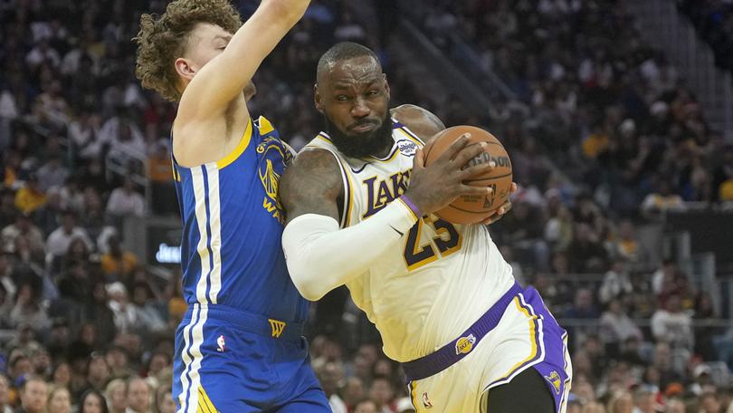 LeBron James #23 of the Los Angeles Lakers drives to the basket on Brandin Podziemski #2 of the Golden State Warriors during the first half at Chase Center on December 25, 2024 in San Francisco, California. N