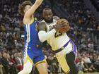 LeBron James #23 of the Los Angeles Lakers drives to the basket on Brandin Podziemski #2 of the Golden State Warriors during the first half at Chase Center on December 25, 2024 in San Francisco, California. N