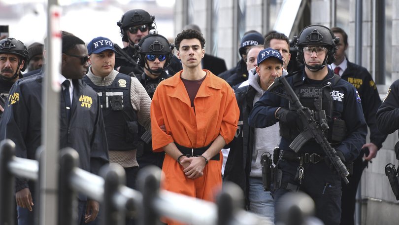 Luigi Mangione, a suspect in the fatal shooting of United Healthcare CEO Brian Thompson, is escorted by police, Thursday, Dec. 19, 2024, in New York.