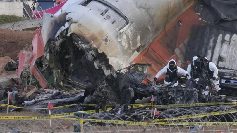 US and Boeing officials have joined the investigation into the Jeju Air plane crash in South Korea. (AP PHOTO)