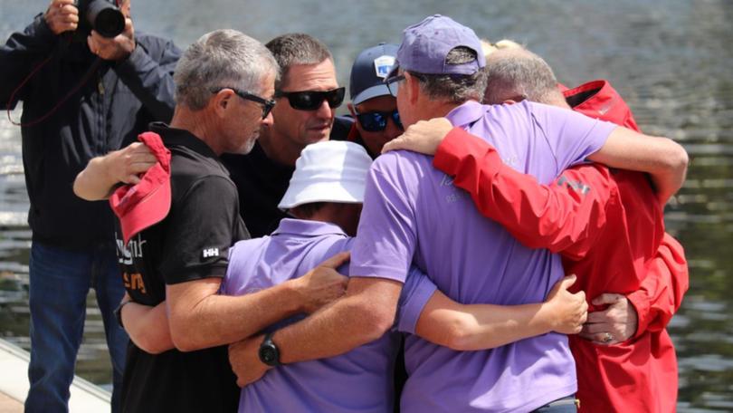 Friends of Nick Smith and Roy Quaden have come together at a service at Constitution Dock in Hobart. (Ethan James/AAP PHOTOS)