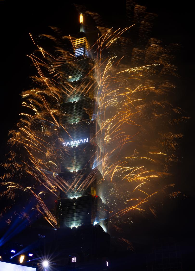 Fireworks light up the Taiwan skyline and Taipei 101 during New Year's Eve celebrations in front of Taipei City Government.