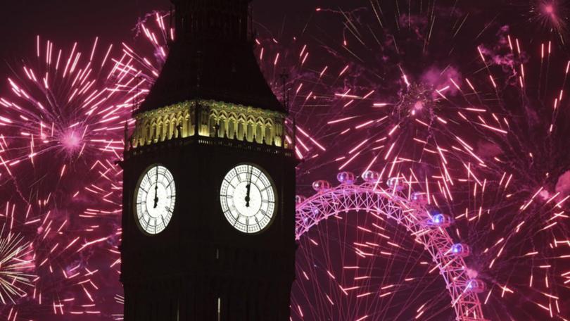 Fireworks over Big Ben and the London Eye in central London. 