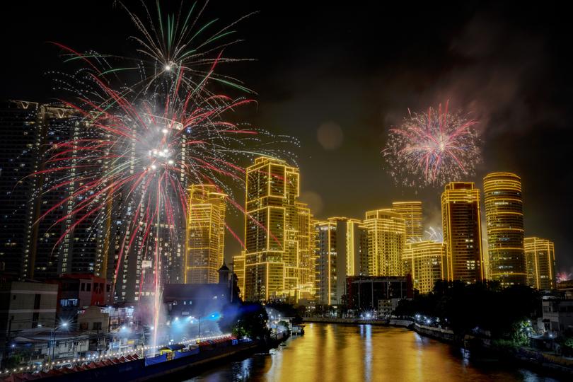 Fireworks explode over skyscrapers during New Year celebrations on January 01, 2025 in Makati, Metro Manila, Philippines.  