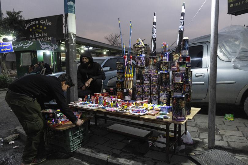 Vendors sell fireworks on the sidewalk on New Year’s Eve in Damascus, Syria, on Tuesday, Dec. 31, 2024. 