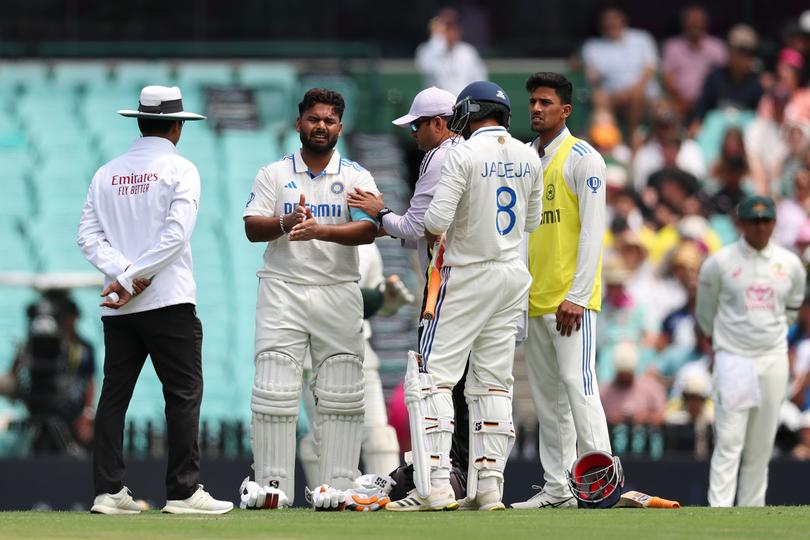 SYDNEY, AUSTRALIA - JANUARY 03: Rishabh Pant of India receives medical treatment after being struck by the ball during day one of the Fifth Men's Test Match in the series between Australia and India at Sydney Cricket Ground on January 03, 2025 in Sydney, Australia. (Photo by Cameron Spencer/Getty Images)