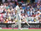 Virat Kohli looks dejected while leaving the field.