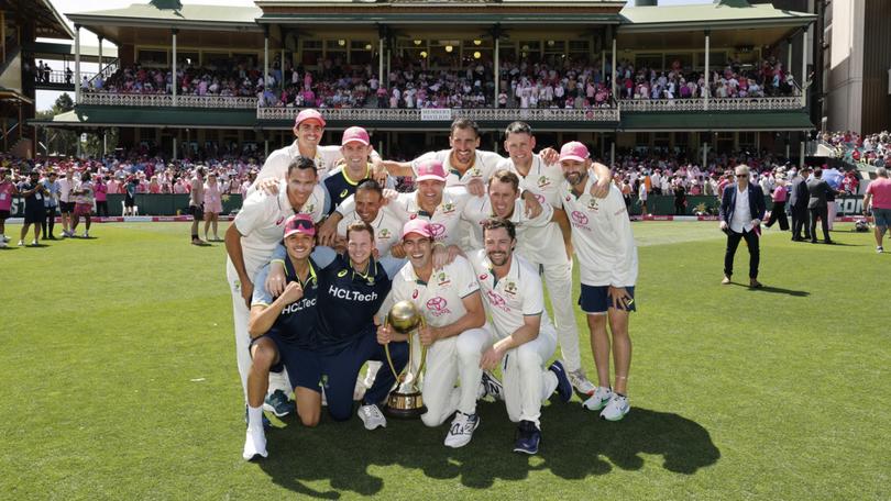 The Australian team pose for a photo after winning the fifth Test.