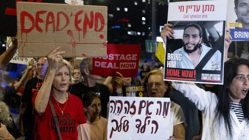 Families and supporters of hostages held in the Gaza Strip hold signs during a demonstration calling for an hostages deal.