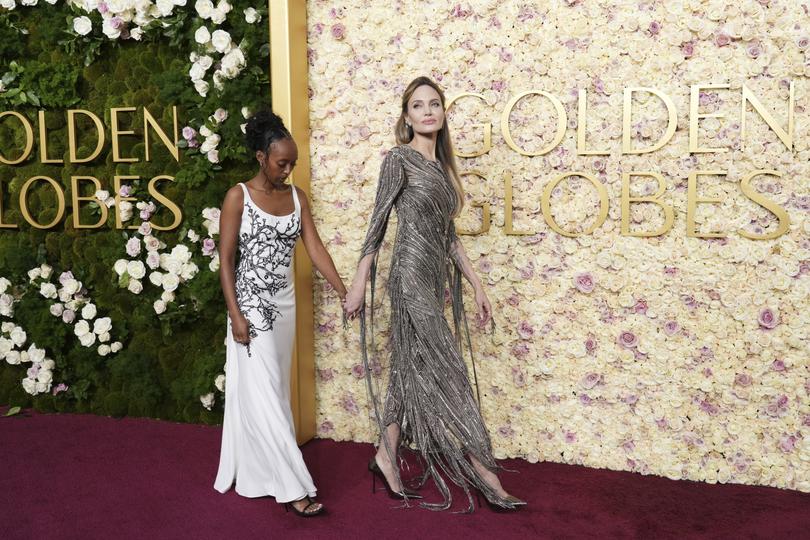 Zahara Jolie, left, and Angelina Jolie arrive at the 82nd Golden Globes on Sunday, Jan. 5, 2025, at the Beverly Hilton in Beverly Hills, Calif. (Photo by Jordan Strauss/Invision/AP)