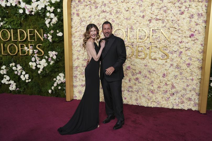 Jackie Sandler, left, and Adam Sandler arrive at the 82nd Golden Globes on Sunday, Jan. 5, 2025, at the Beverly Hilton in Beverly Hills, Calif. (Photo by Jordan Strauss/Invision/AP)