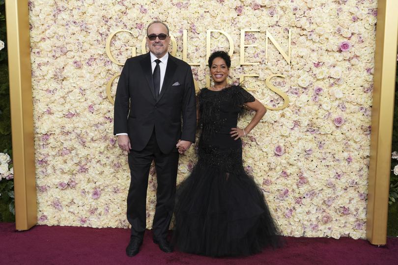 David Zayas, left, and Liza Colon-Zayas arrive at the 82nd Golden Globes.