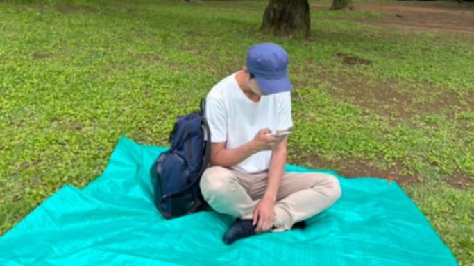 Shoji Morimoto reserving a spot for his client in a park.