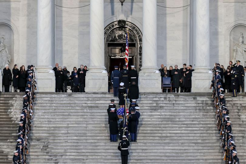 An honour guard carries the casket of late former US President Jimmy Carter into the Rotunda of the US Capitol in Washington, DC.