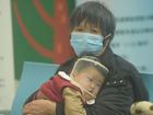 A child, accompanied by their parents, sees a doctor at a pediatric department of a hospital in Hangzhou.