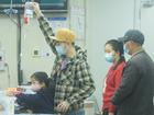 A child, accompanied by their parents, sees a doctor at a pediatric department of a hospital in Hangzhou.