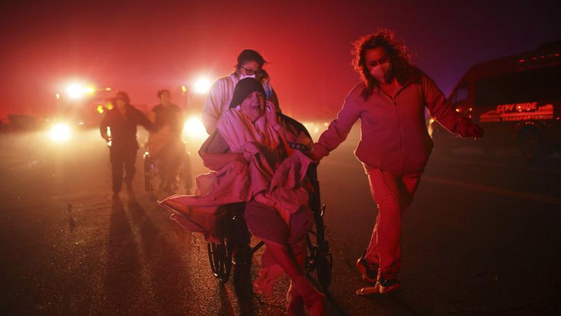 Residents of a senior center are evacuated as the Eaton Fire approaches Tuesday, Jan. 7, 2025 in Altadena, Calif. 