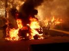 A car burns as the Eaton Fire moves through Altadena, California. 