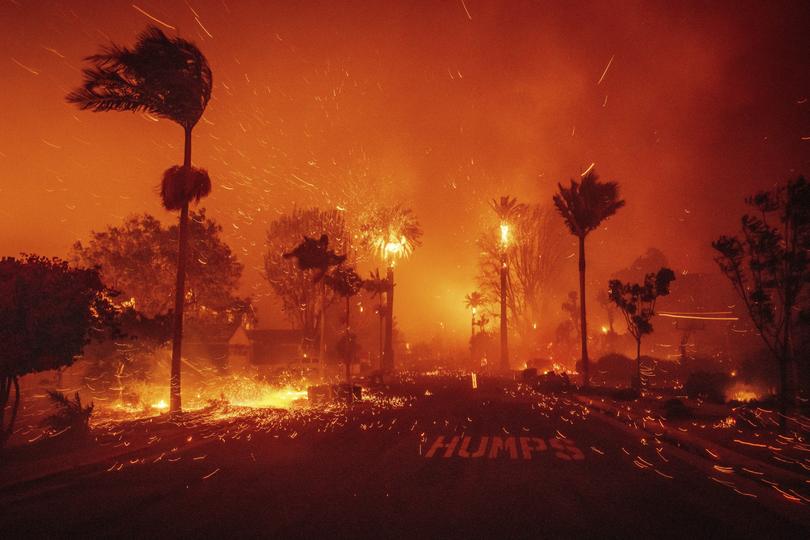 The Palisades Fire ravages a neighbourhood amid high winds.