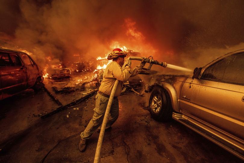 A firefighter battles the Eaton Fire Wednesday, Jan. 8, 2025, in Altadena, Calif. 