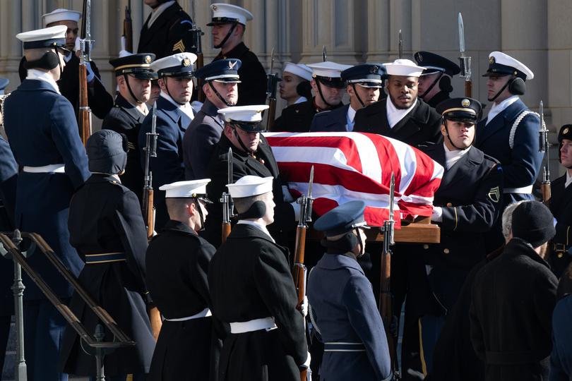 US President Jimmy Carter's casket is carried by an honor guard after a State Funeral Service at the Washington National Cathedral.