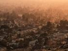 Smoke lingers over a neighborhood devastated by the Eaton Fire, Thursday, Jan. 9, 2025, in Altadena, Calif. (AP Photo/John Locher)