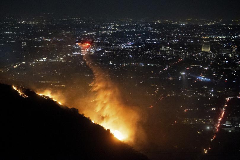 Water is dropped by helicopter on the burning Sunset Fire in the Hollywood Hills section of Los Angeles, Wednesday.