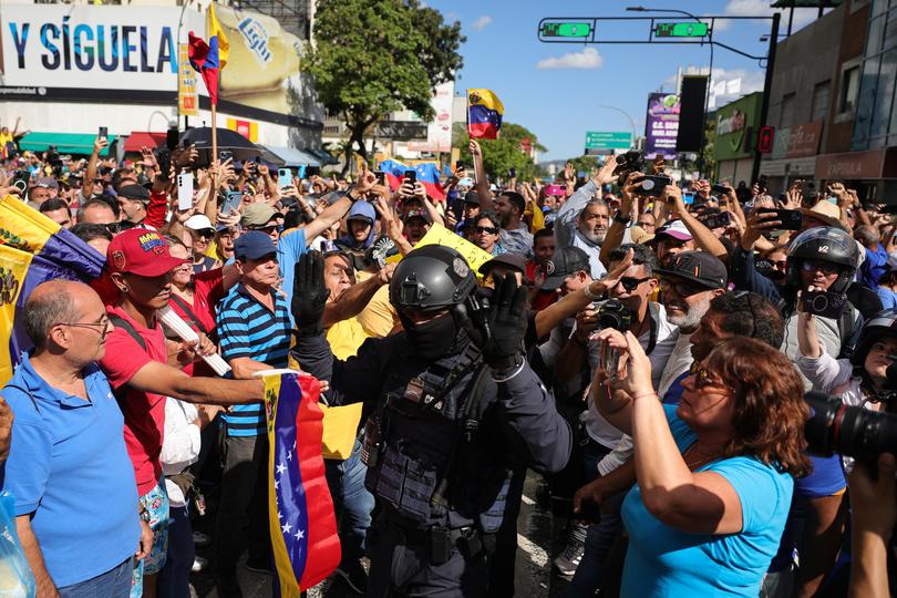 Opposition supporters and Venezuela Motorized Police Force argue during an anti-government protest on January 9.