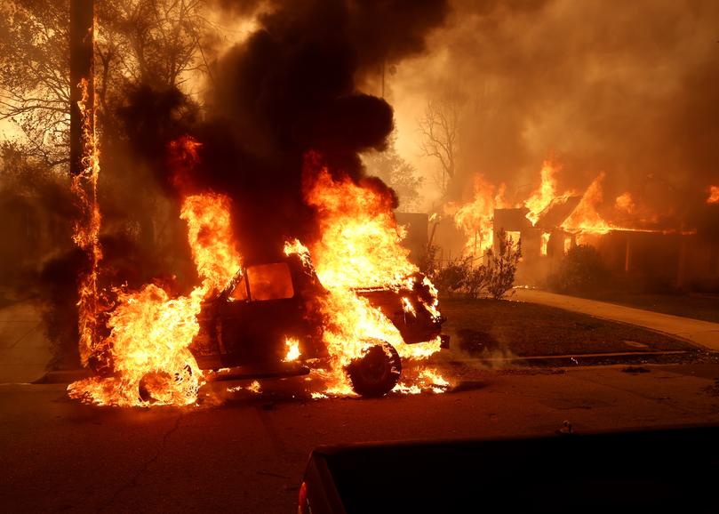 A car burns as the Eaton Fire moves through the area on January 08, 2025 in Altadena, California. 