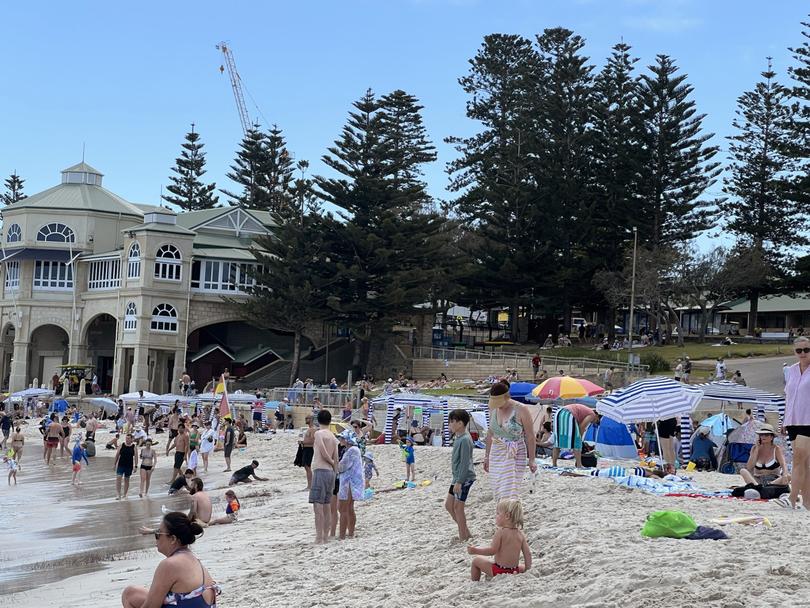 Cottesloe Beach is packed with beachgoers, cabanas and umbrellas on New Years Day, 2025.