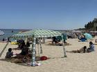 Cottesloe Beach is packed with beachgoers, cabanas and umbrellas on New Years Day, 2025