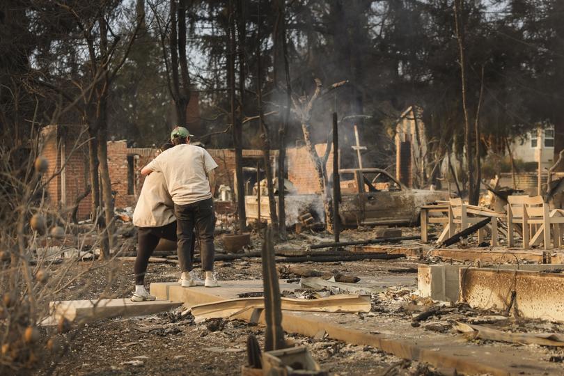 People embrace while looking over the remains of a home that was destroyed by the Eaton wildfire in the Altadena, California, USA, 09 January 2025. 