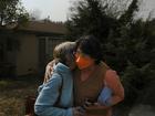 A neighbor, right, consoles a woman who lost her home to the Eaton Fire. (MUST CREDIT: Jen Osborne for The Washington Post)