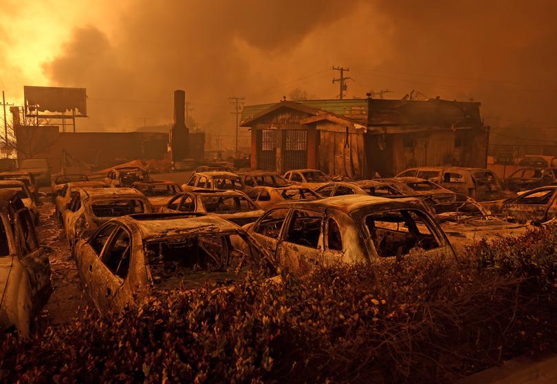 Cars destroyed by the Eaton Fire sit in the parking area of a burned auto shop on January 08, 2025 in Altadena, California. 