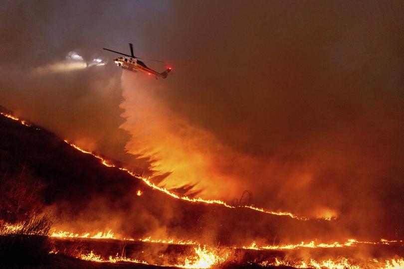 Water is dropped by helicopter on the Kenneth Fire in the West Hills section of Los Angeles.