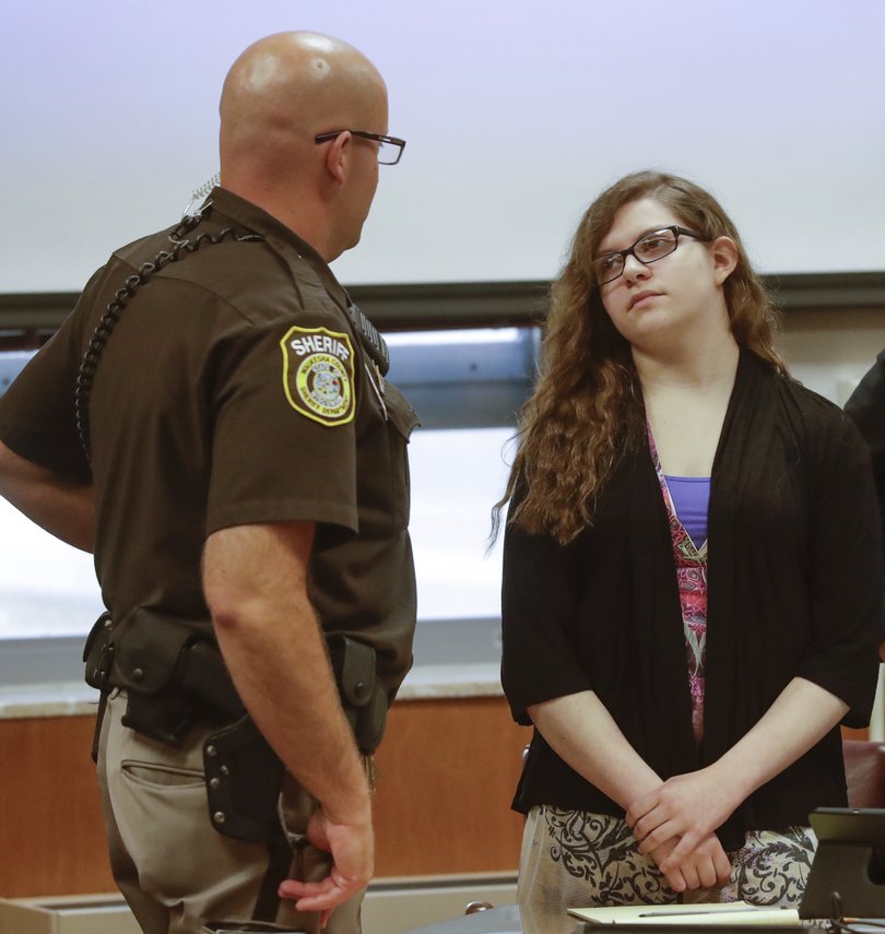 Anissa Weier talks to a sheriff's deputy during a pause in jury selection in the trial to determine 15-year-old Weier's competency at Waukesha County Courthouse Monday, Sept 11, 2017, in Waukesha, Wisconsin. 