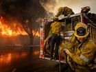 Firefighters work to extinguish a fire at the Altadena Golf Course on Thursday. 