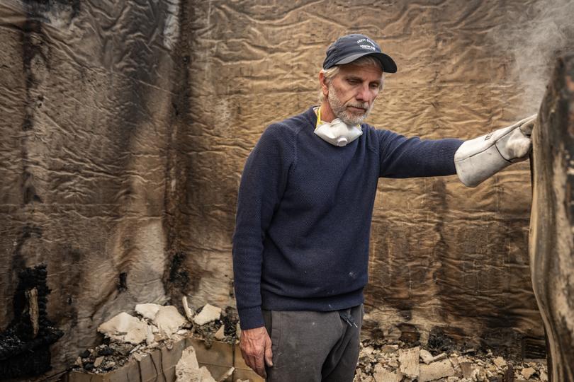 Esteban Nazarian inspects his ruined home in Altadena. He and his wife moved there in 1994 and raised their children. 